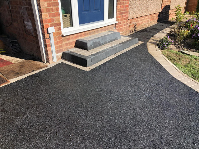 Steps in tarmacadam and block.